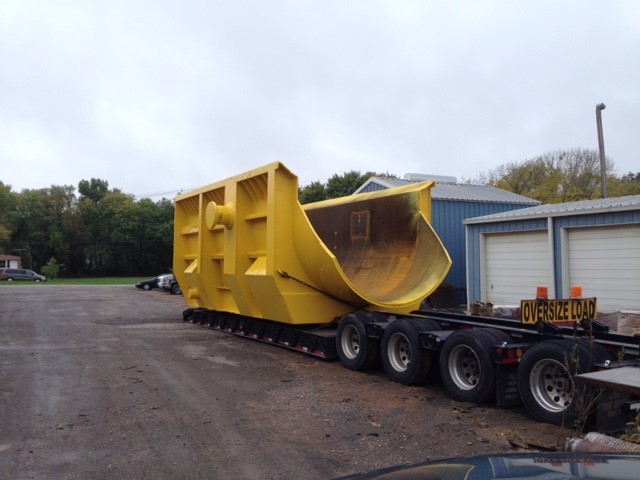 Heavy equipment loaded on specialized flatbed trailer